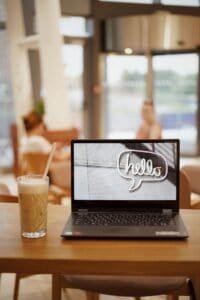 laptop sitting on a wood table in a cafe